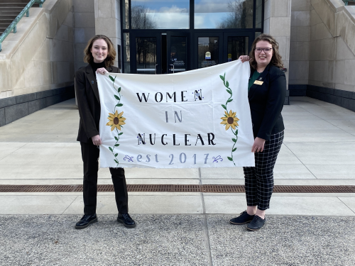 Morgan Smith and Liz Bramer standing in front of the Indiana State House in Indianapolis, Indiana.